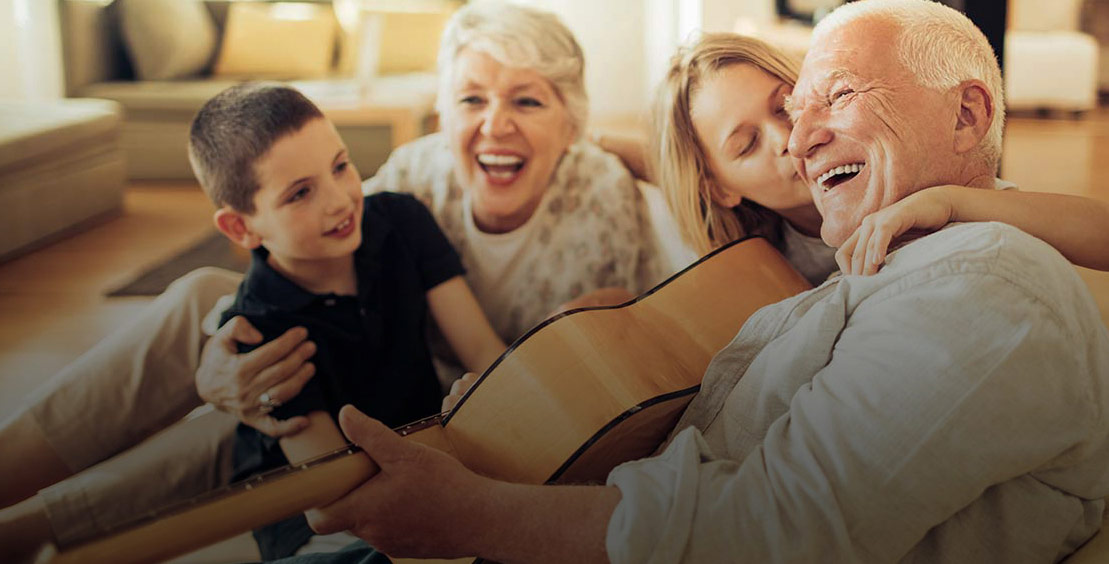 grandparents playing guitar with kids